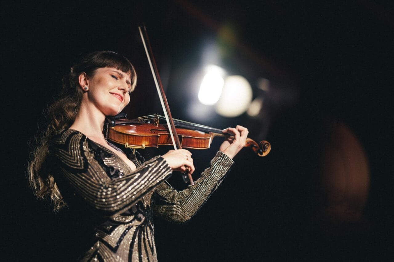 Smuikininkė Ieva Pranskutė groja scenoje, jos muzika jungia Lietuvos tradicijas ir pasaulinę sceną vienoje erdvėje