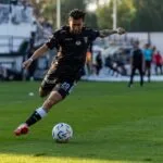 Futbolo sirgaliai su atributika stebi tiesioginę transliaciją po atviru dangumi per FIFA World Cup Vilniuje renginį.