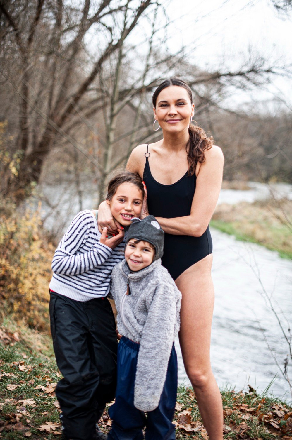 Ignė Degutytė su maudymosi kostiumėliu ir vaikais prie upės rudenį
